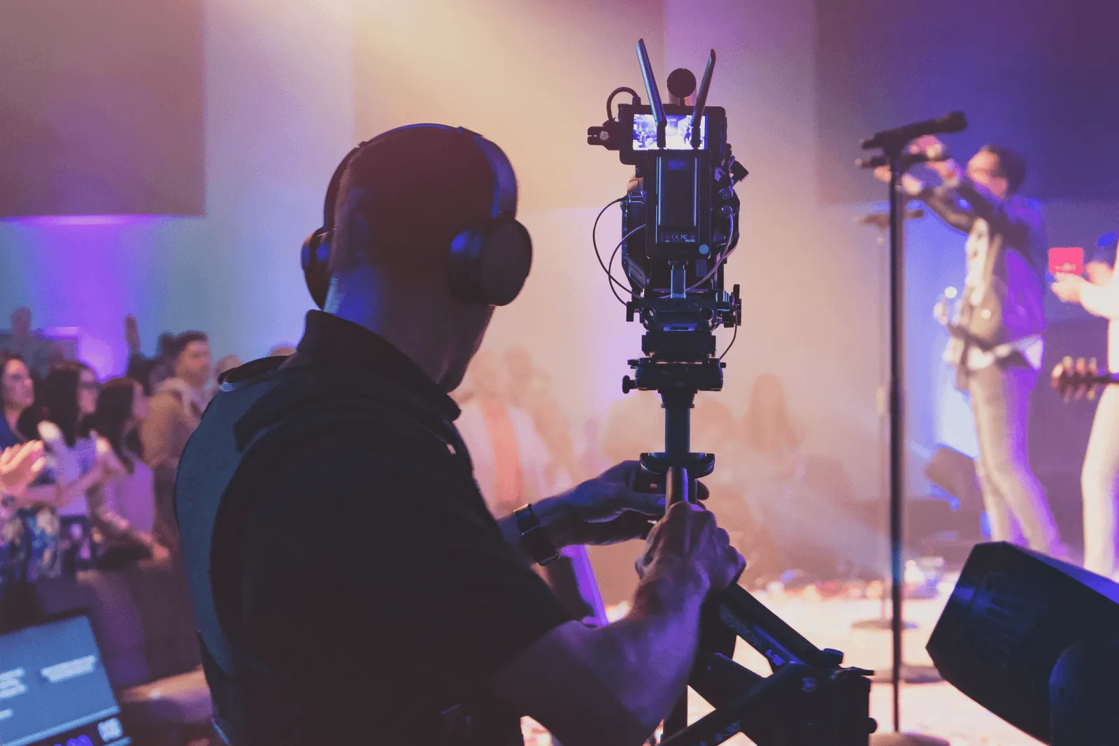 Videographer recording a live worship event